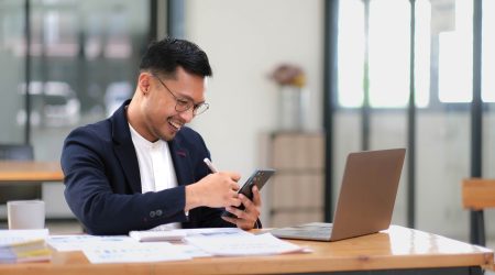 Portrait of a male business owner showing a happy smiling face as he has successfully invested his